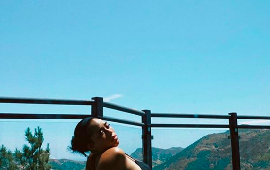 Jordyn Woods Flaunts Toned Figure While Sunbathing In Black Bikini [PHOTOS]